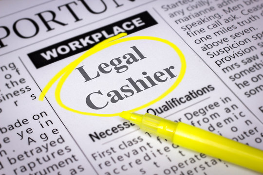 Legal Cashier - Newspaper sheet with ads and job search, circled with yellow marker, Blurred image and selective focus