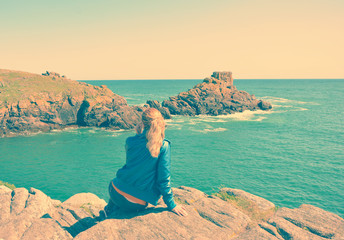 Young woman on a rocky coast