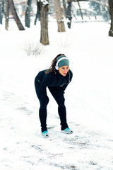 Fototapeta na wymiar Female athlete jogging in park in winter