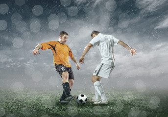 Football player with ball in action under sky with clouds