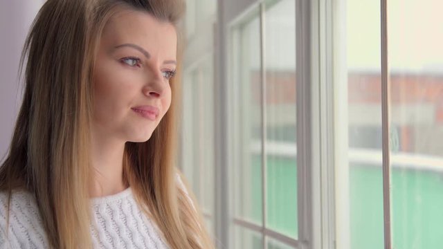 4K Attractive woman in thought looking out of a train window