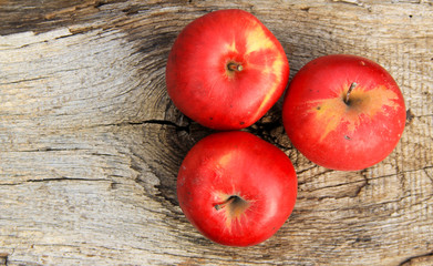 Red apples on wooden background