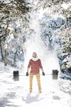 Man doing deadlift in winter woods