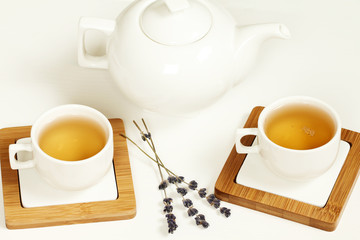 Hot tea in white cup and teapot