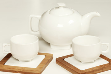 Fototapeta na wymiar White cup and teapot fot tea or coffee