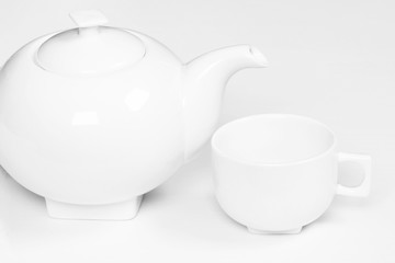 White cup and teapot fot tea or coffee