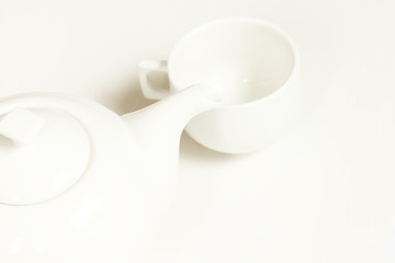 Hot tea in white cup and teapot