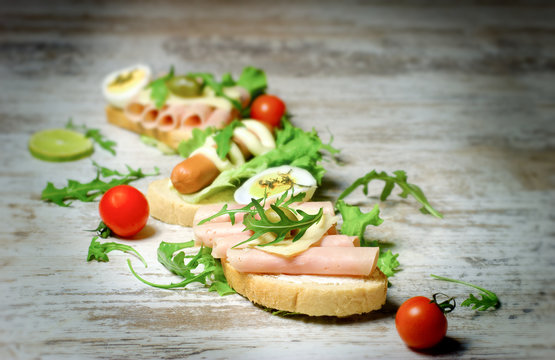 Sandwich with ham and sandwich with hot dog-frankfurter on rustic table