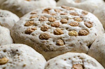 Kneaded homemade bread, prepared for putting in the oven with some cornflakes on top