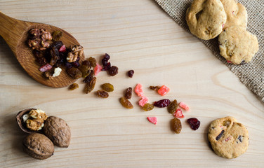Healthy homemade cookies and some of the ingredients spilled on the table - top view