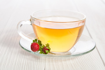 Cup of tea and strawbarries on the white wooden table