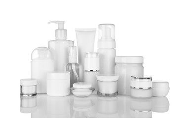 Different cosmetic bottles on white background