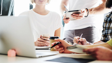A cropped photo of the meeting process with the hands holding different electronic devices in...