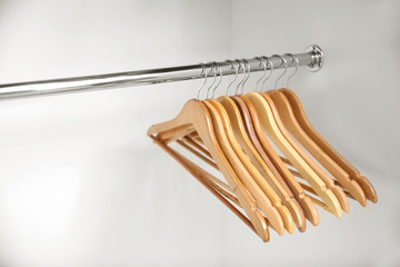 Wooden coat hangers on clothes rail
