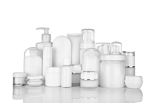 Different cosmetic bottles on white background
