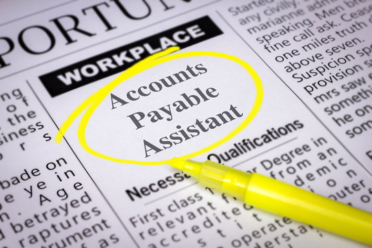 Accounts Payable Assistant - Newspaper sheet with ads and job search, circled with yellow marker, Blurred image and selective focus