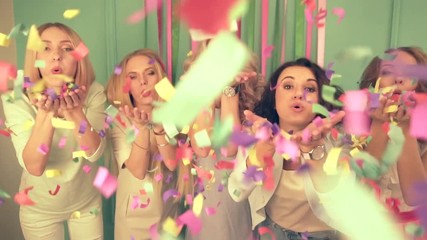 Slow motion shot of five women blowing confetti to the camera. Concept of funny girlfriends hen-party.