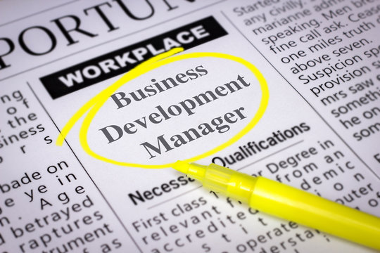 Business Development Manager - Newspaper sheet with ads and job search, circled with yellow marker, Blurred image and selective focus