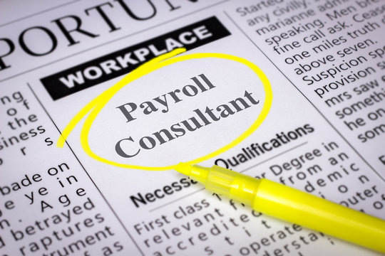 Payroll Consultant - Newspaper sheet with ads and job search, circled with yellow marker, Blurred image and selective focus
