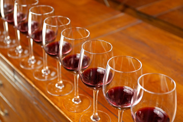 Row of glasses with red wine on bar counter