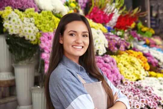 Pretty young florist in flower shop