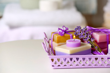 Obraz na płótnie Canvas Set of body care cosmetics with lavender on table closeup