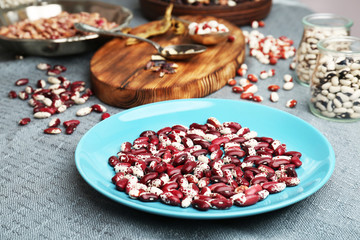 Blue plate with dried haricot beans on table