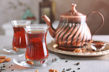Turkish tea in traditional glasses on table, closeup