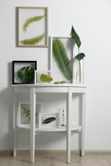 Frames with green leaves in interior on white background