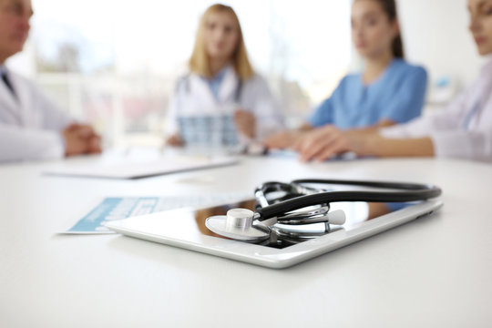 Tablet and stethoscope on table in clinic