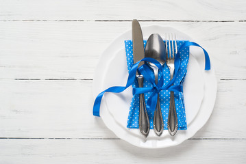 Table setting with white plates blue napkin