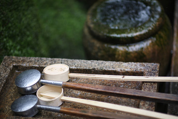 Buckets for washing hands before visiting Shinto shrines at the water source