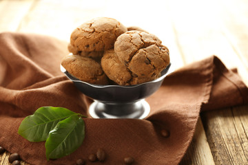 Bowl with delicious cookies on brown napkin