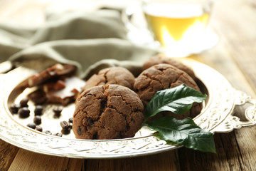 Tray with tasty homemade cookies and coffee beans, closeup