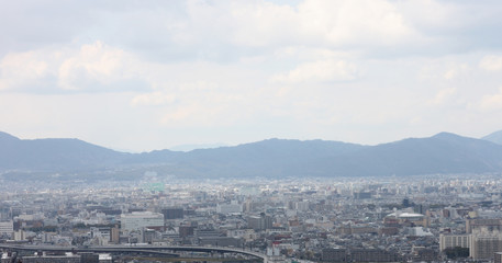 Panoramic image of the modern city at the foot of the mountain range