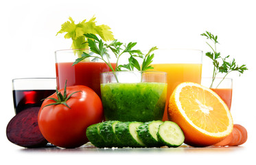 Glasses with fresh organic vegetable and fruit juices on white