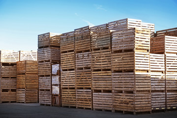 Wooden boxes in open-air warehouse on sunny day