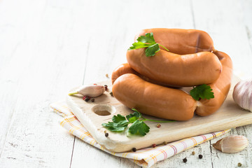 Uncooked sausages on cutting board