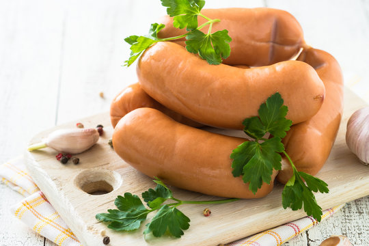 Uncooked sausages on cutting board
