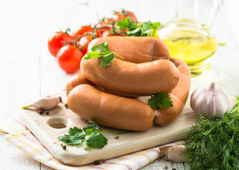 Uncooked sausages with vegetables