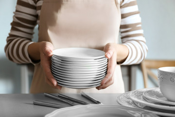 Closeup of female hands holding saucers