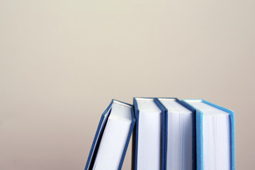 Books in a row on grey background