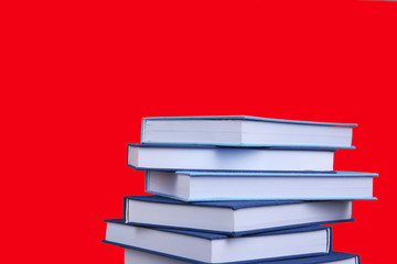 Pile of books on red background