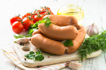 Uncooked sausages with vegetables