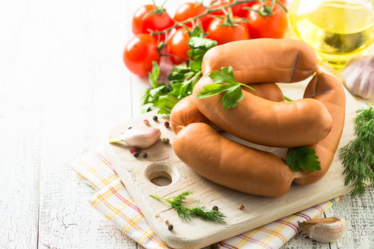 Uncooked sausages with vegetables