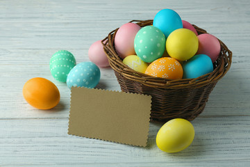 Easter eggs on wooden background with blank card