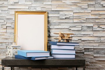 Books on table near textured wall
