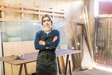 Attractive woman working as a carpenter