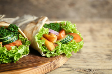 Delicious kebab sandwiches on wooden board