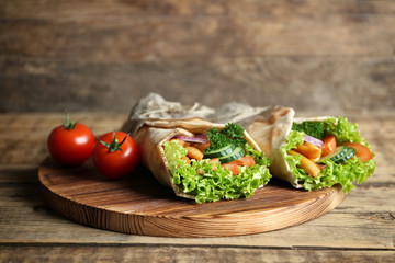 Delicious kebab sandwiches on wooden board